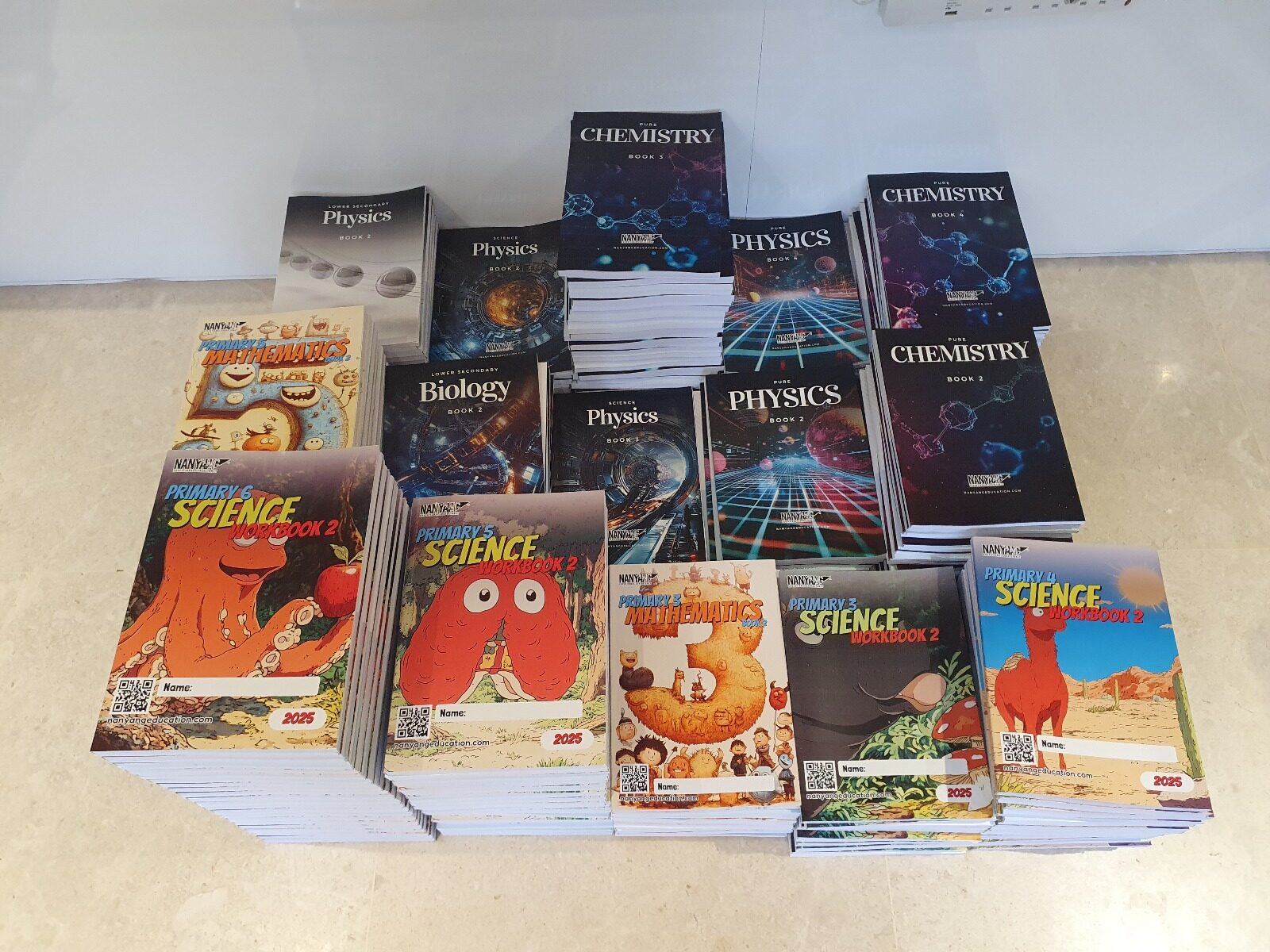 Stack of books printed by Print Print. Bulk printing here is one of the affordable book printing strategies in Singapore.