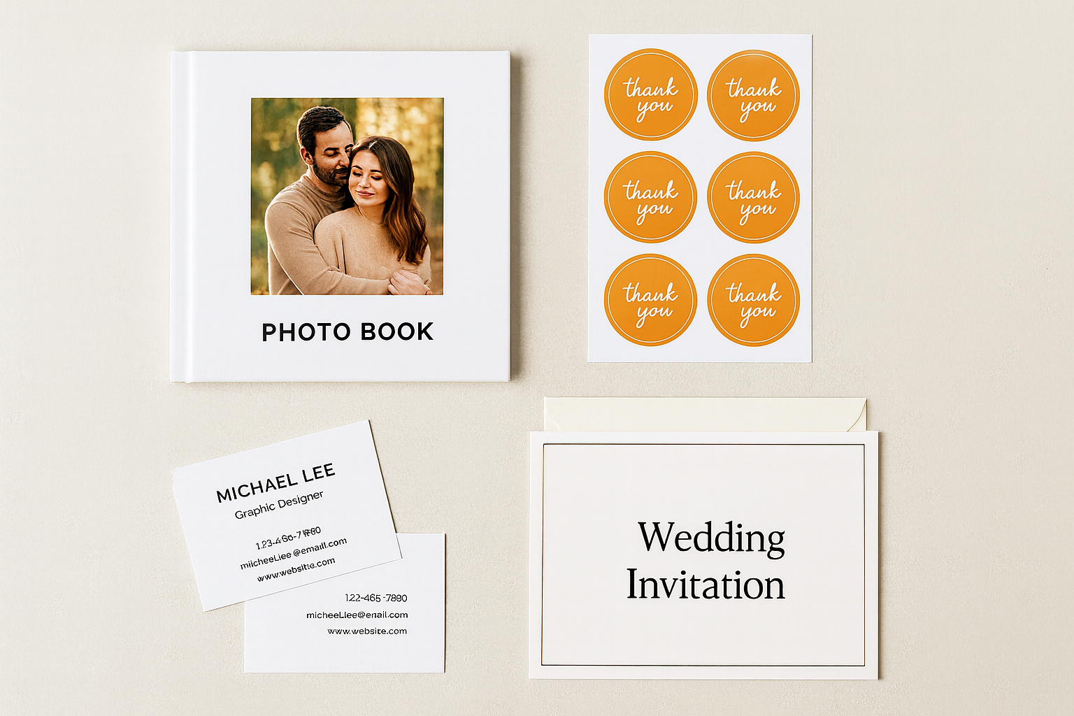 Flat lay of custom-printed products including a photo book, thank-you stickers, business cards, and a minimalist wedding invitation card labelled ‘Wedding Invitation’, representing personalised custom printing in Singapore.