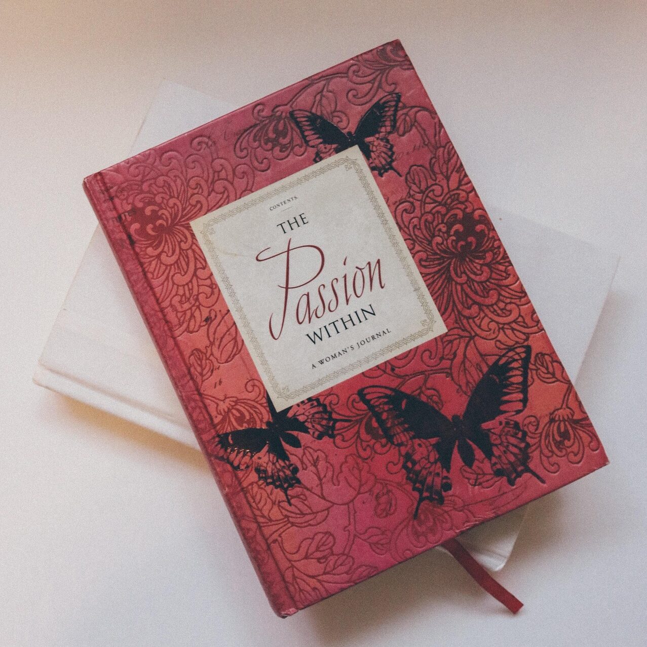 Hardcover book with premium embossed cover and ribbon marker, example of hardcover book printing in Singapore.