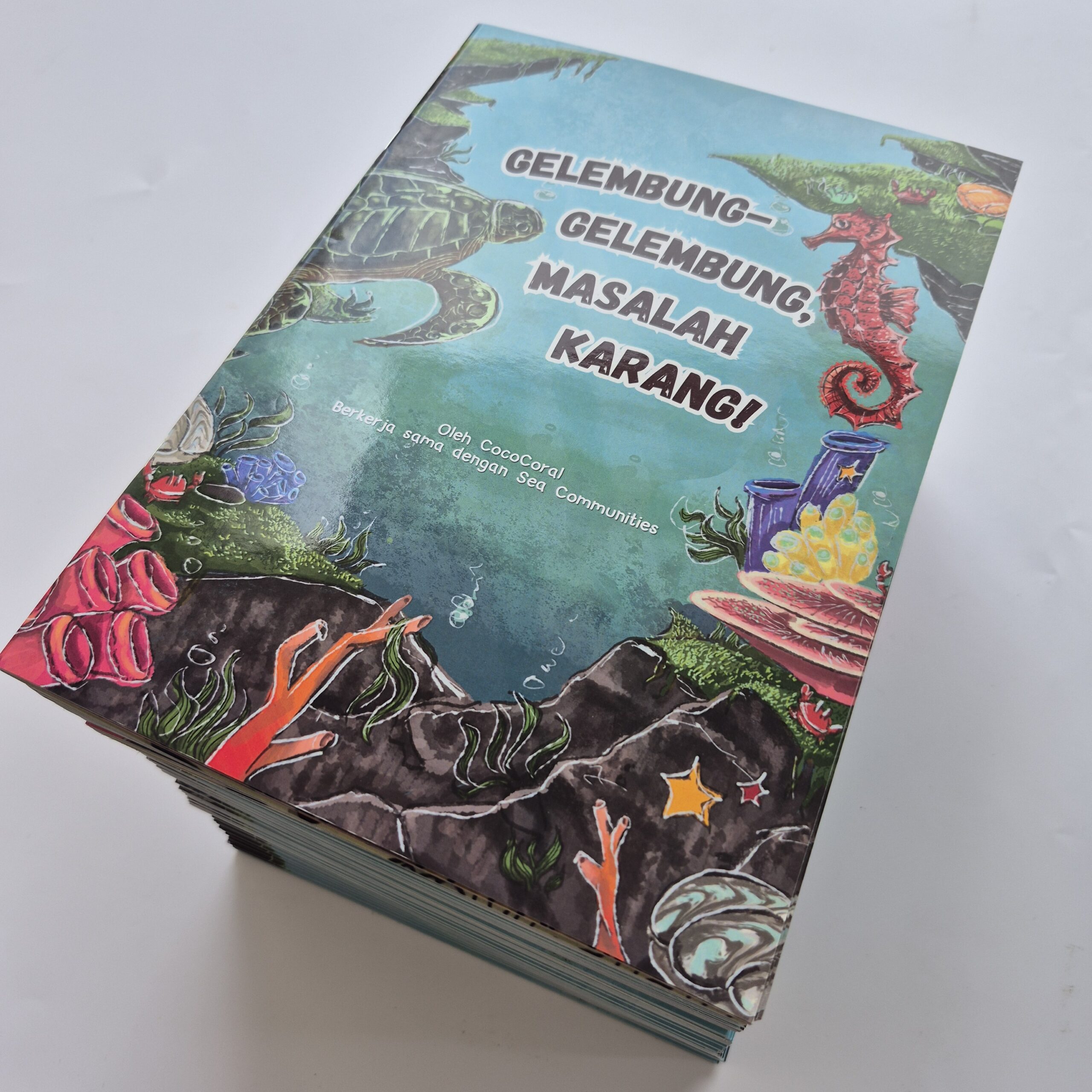 Hardcover book vs perfect binding comparison guide — stack of hardcover books with illustrated cover representing durable book printing in Singapore