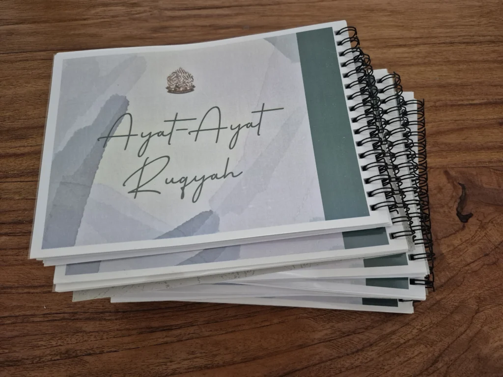 Stack of books with coil binding – black spiral binding and elegant minimalist covers, printed on premium paper — showcasing professional coil binding quality in Singapore.