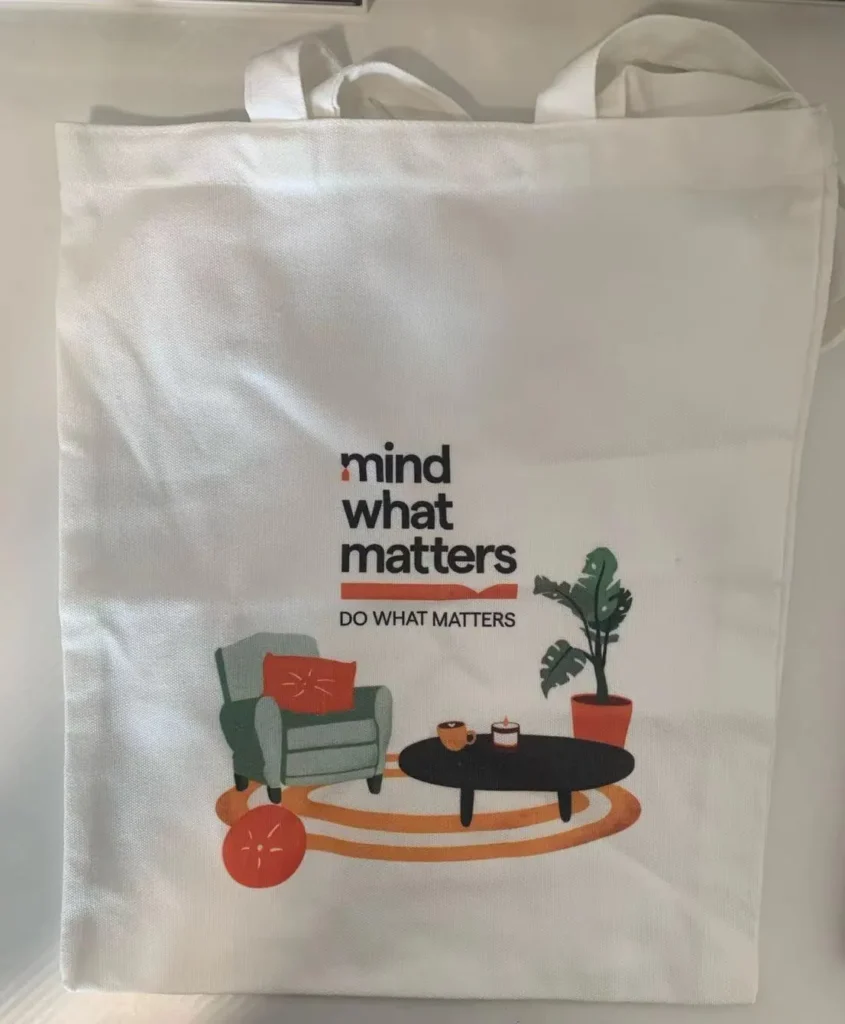 Custom tote bag printing in Singapore featuring a modern illustrated design on white cotton fabric.