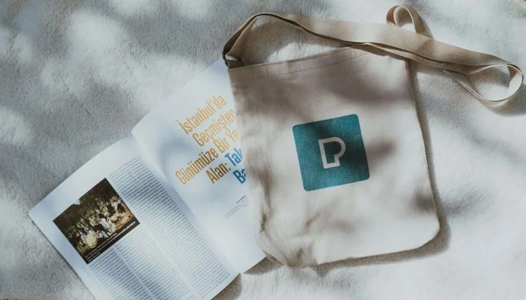 tote bags vs flyers comparison showing branded canvas tote bag used for marketing.