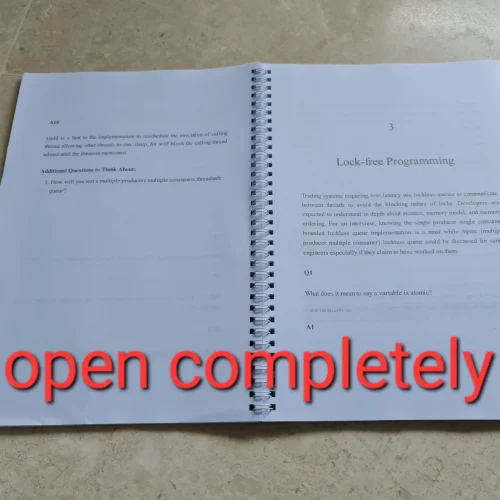Coil bound training manual titled “Trading Systems Developer Interview Guide (C++ Edition)” printed with white spiral binding on beige background