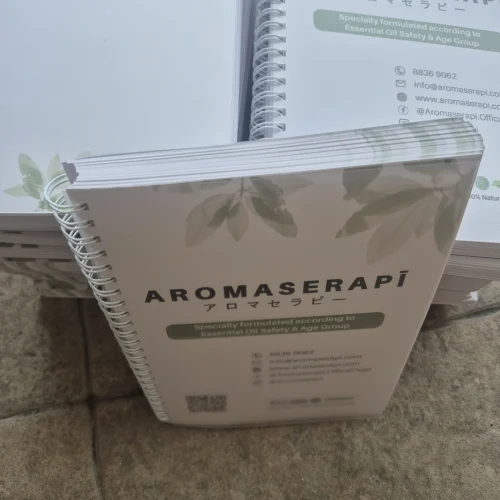 Coil bound product manuals printed for Aromaserapi, featuring white spiral binding and professional matte covers, produced by a printing service in Singapore.
