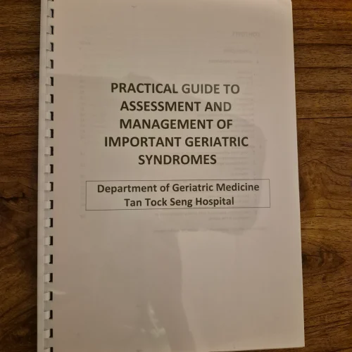 comb-binding-training-materials Comb binding booklet for medical training — “Practical Guide to Assessment and Management of Important Geriatric Syndromes” by Tan Tock Seng Hospital, printed with clear plastic cover and white comb spine.