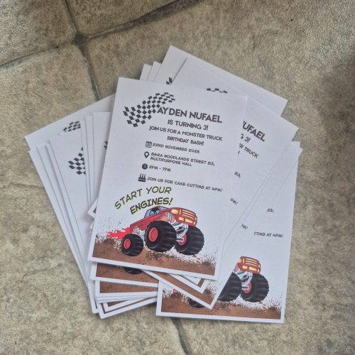 Custom birthday party invitation flyers featuring a monster truck theme — printed in vibrant colours on matte paper for a children’s event.